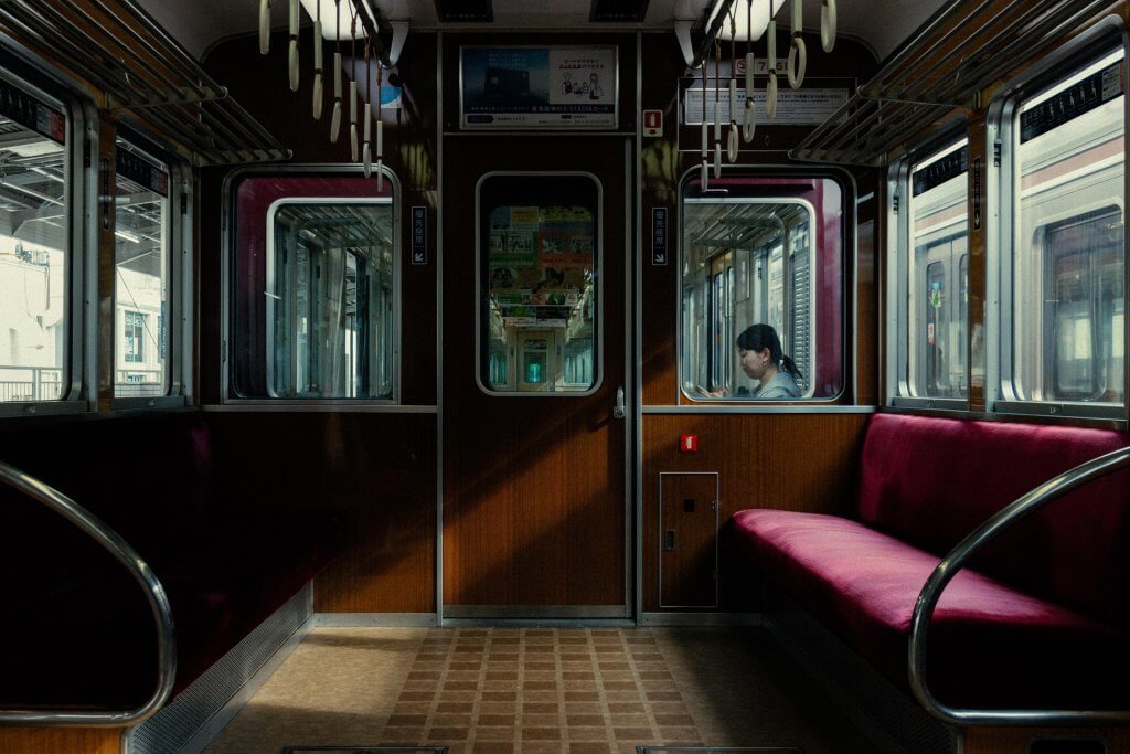 Luxurious train with red seats and woman in the back